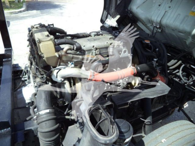 Isuzu NPR/NRR engine bay showing turbocharged diesel engine and intake hoses.
