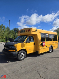 2018 Chevrolet Express G4500 mini school bus in yellow, side view showing stop sign and school bus lettering