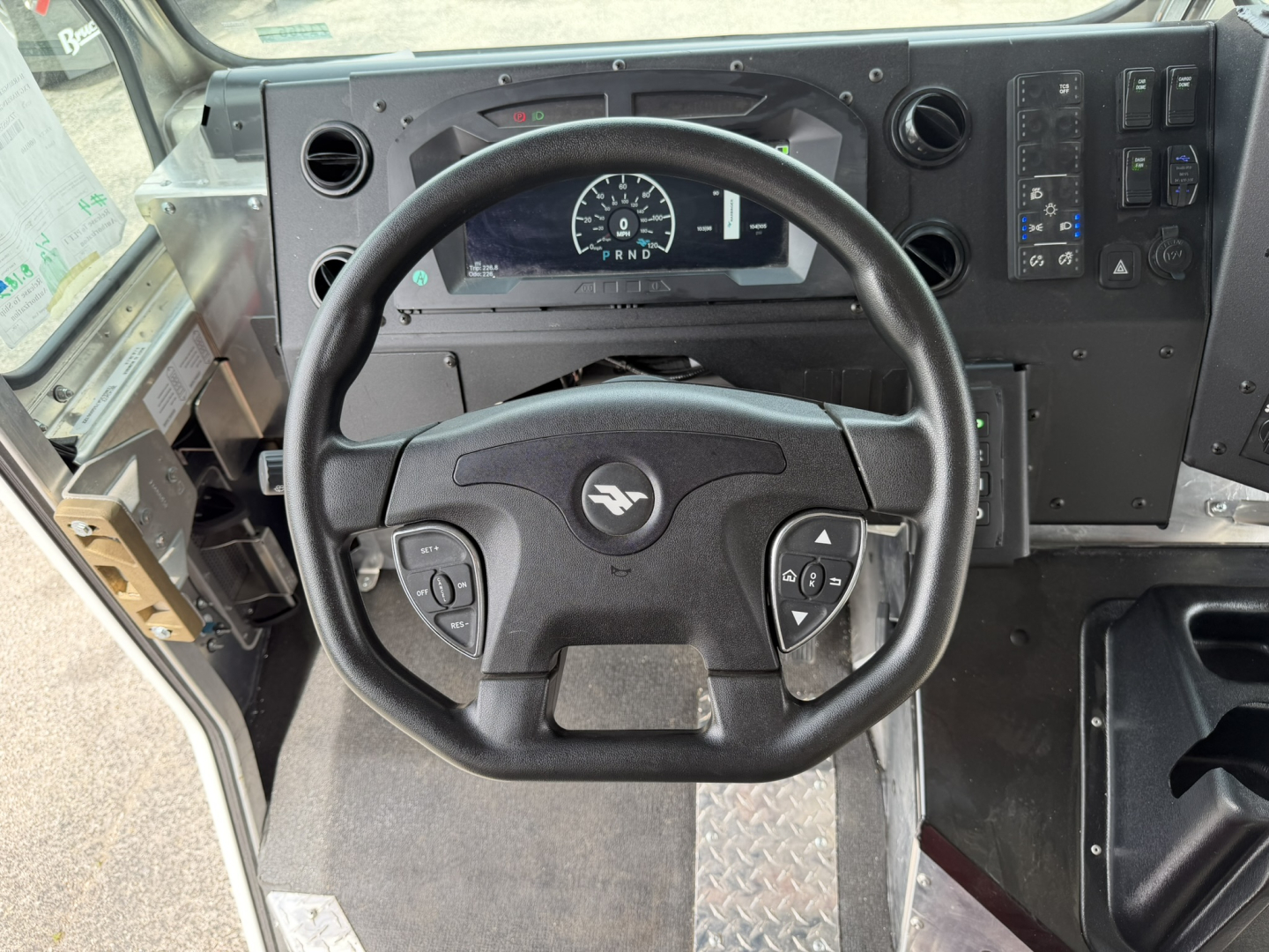Harbinger S554 dash and steering wheel view showing gauge cluster and control panel, black steering wheel with center emblem, dashboard with digital display and switches.
