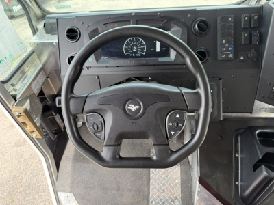 Harbinger S554 dash and steering wheel view showing gauge cluster and control panel, black steering wheel with center emblem, dashboard with digital display and switches.