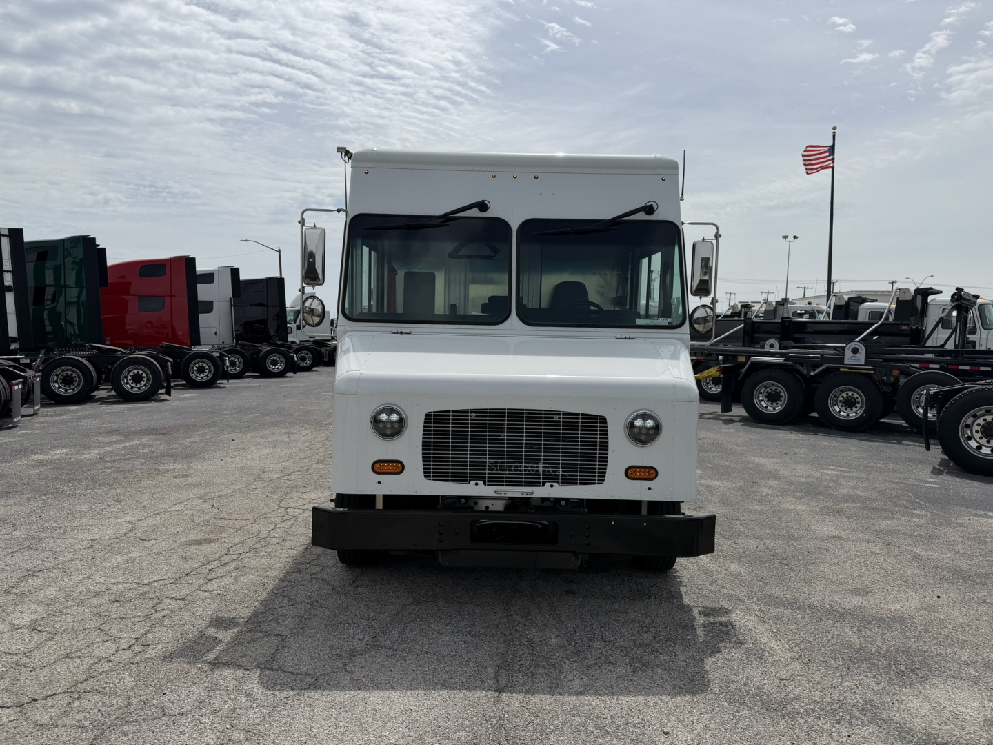 Harbinger S534 step van front view showing grille, headlights, and bumper in a dealership lot.