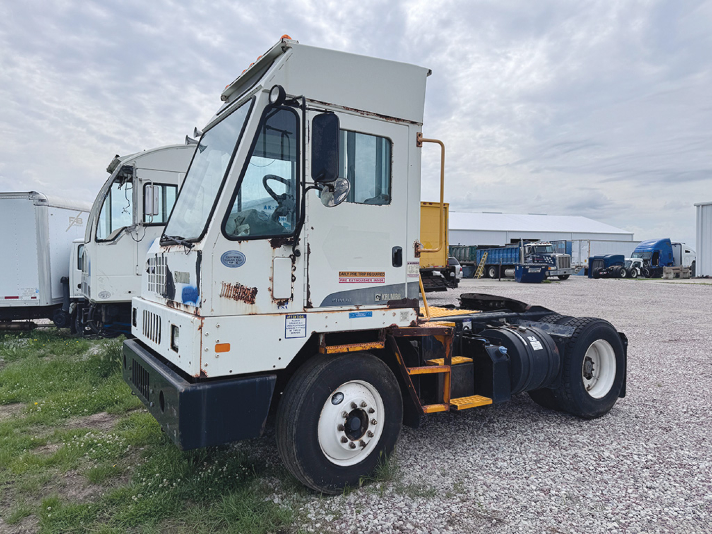 Kalmar Ottawa yard truck tractor side view showing cab, fuel tank, and rear dual wheels.