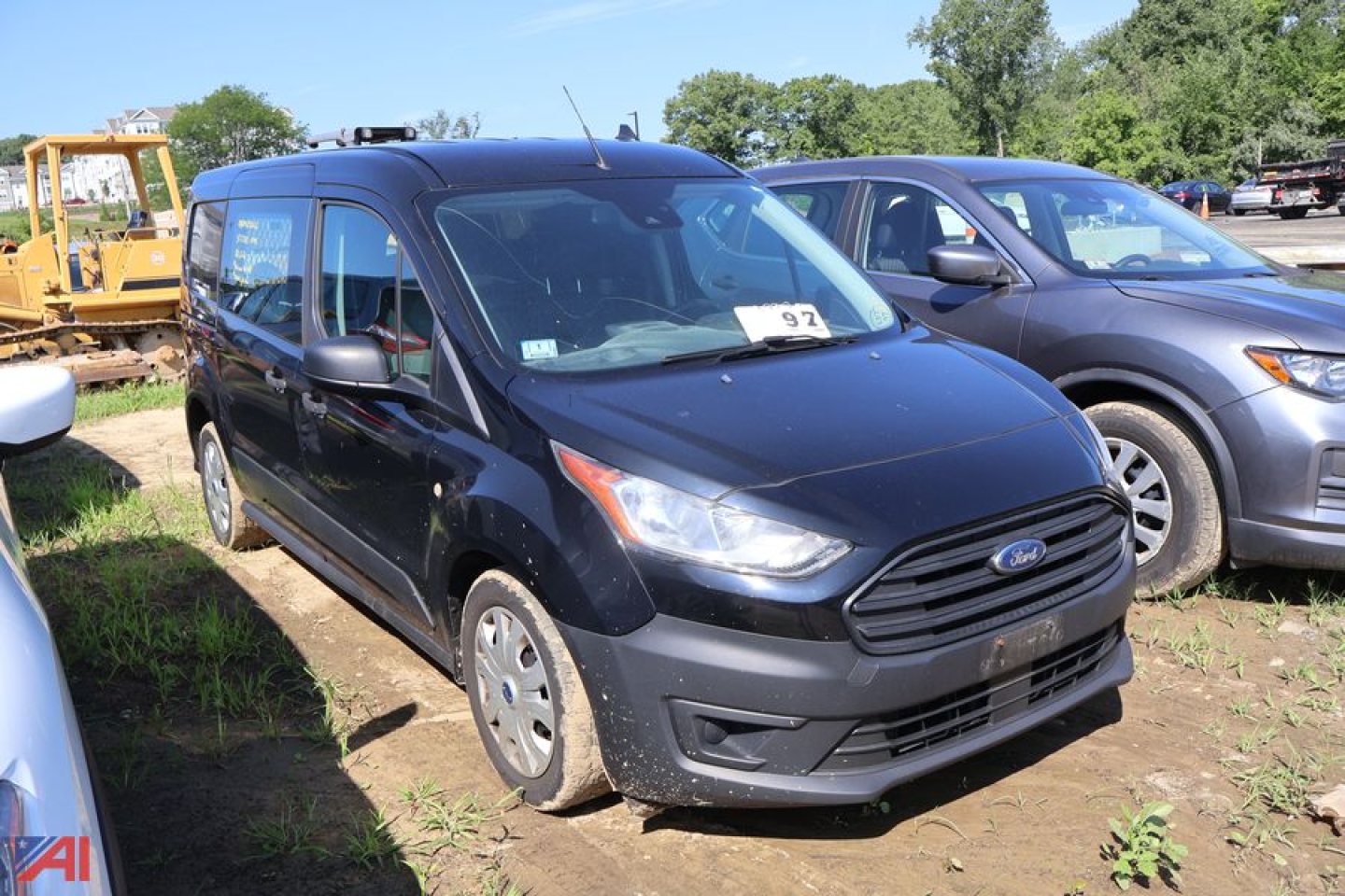 Ford Transit Connect van in a parking lot showing front and left side with black exterior and slotted grille.