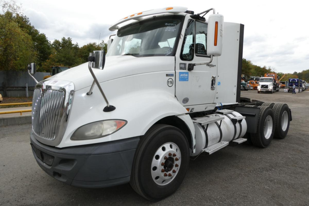 International ProStar+ 113 day cab truck showing front left view with white cab and chrome grille