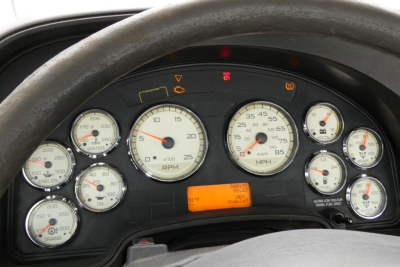 Dashboard cluster of a 2013 International PROSTAR+ 113 showing multiple gauges and an orange digital readout.
