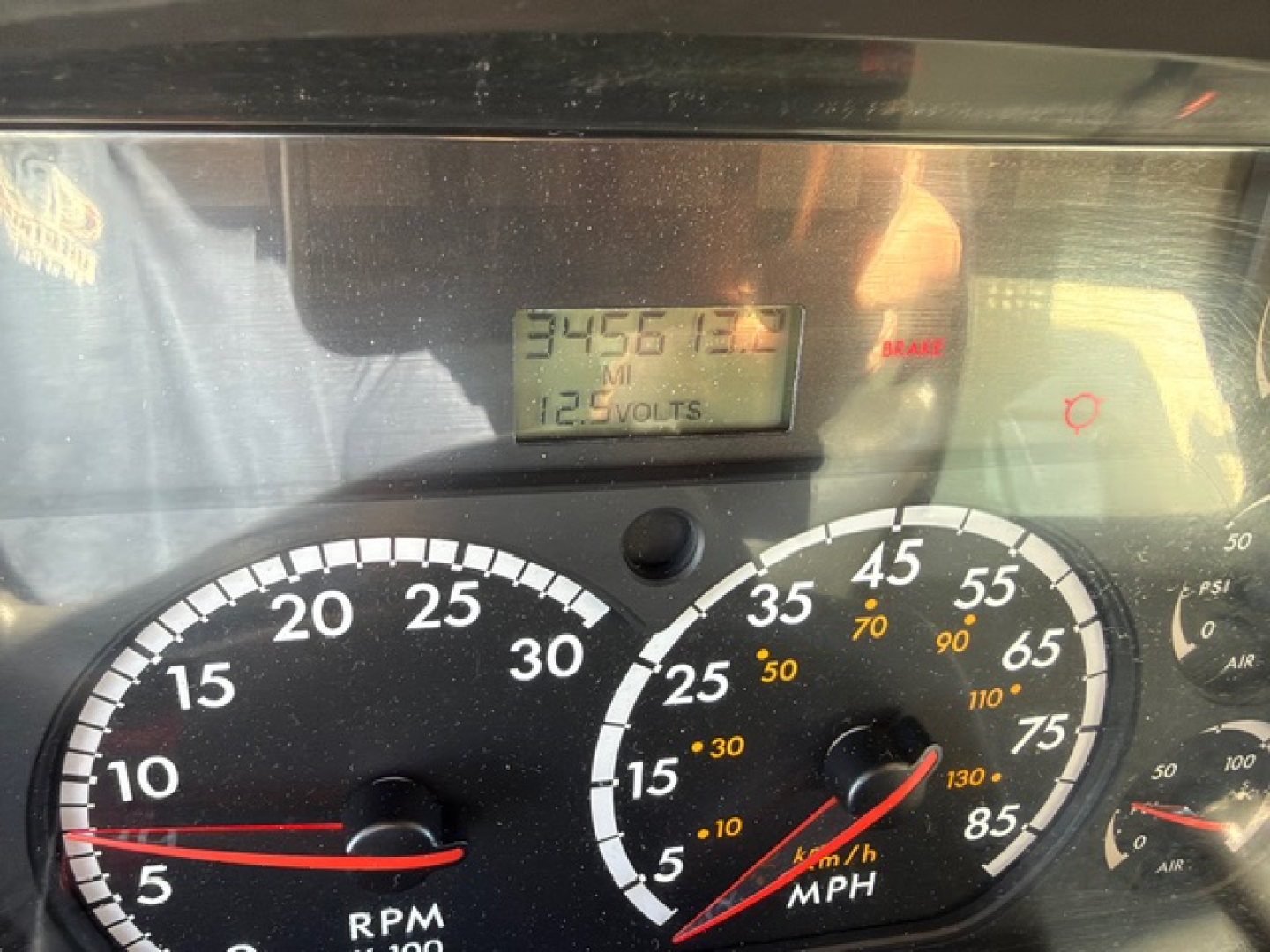 Dashboard of a Freightliner M2 106 showing RPM gauge and speedometer with digital readout visible; numbers and dials in view