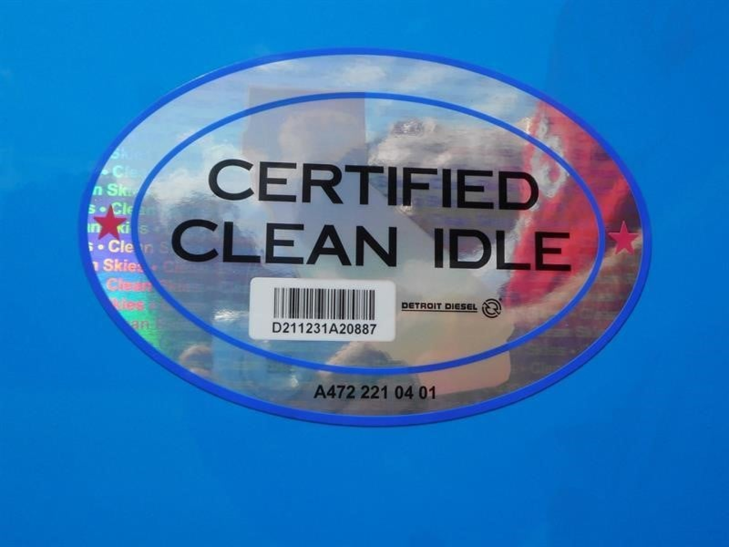 Certified Clean Idle sticker on blue surface with barcode and Detroit Diesel logo.