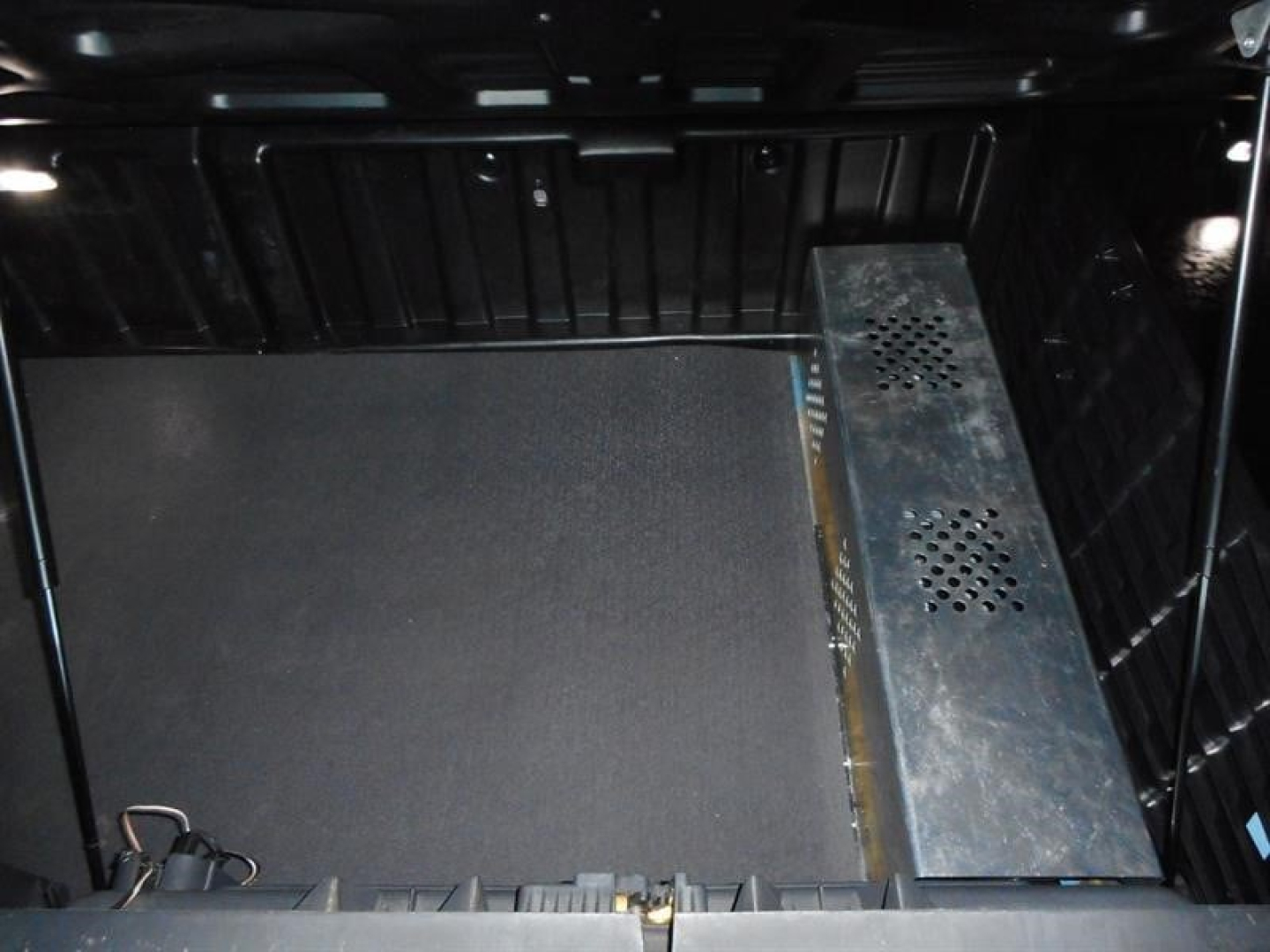 Freightliner Cascadia interior with storage area and metal equipment mount.