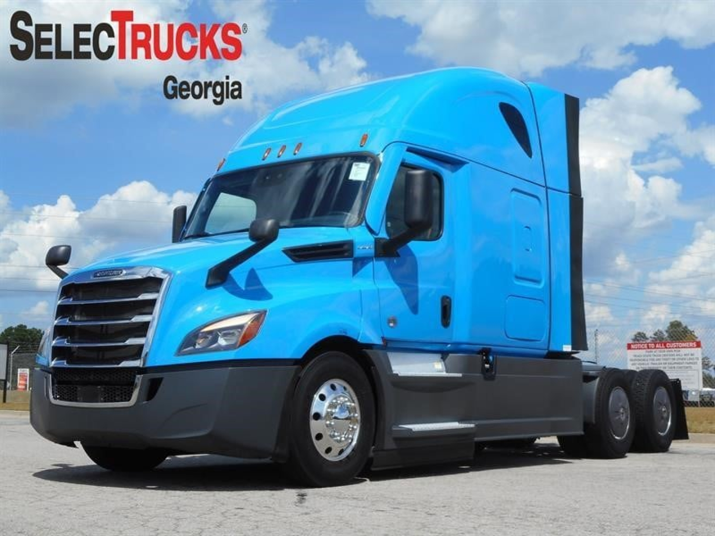 Freightliner Cascadia 126 tractor in blue, side view showing aerodynamic cab, chrome wheels, and sleeper configuration.