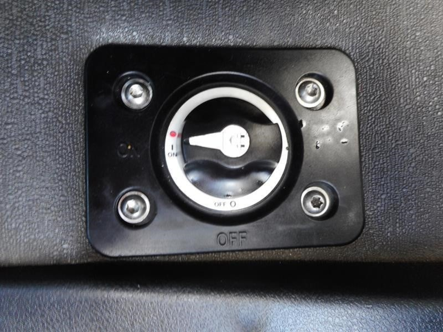 Cab switch panel with circular dial showing OFF position on Freightliner Cascadia truck dash area