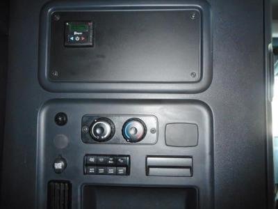 Cab interior of a Freightliner Cascadia 126 showing control panel with toggles, climate knobs, and storage compartments.