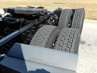 Truck chassis showing dual rear axles and tires with heavy tread, part of Freightliner Cascadia 126 undercarriage.