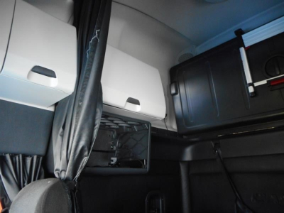 Truck sleeper cab interior showing storage compartments and paneling in view