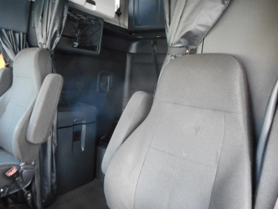 Truck cab interior of a 2023 Freightliner Cascadia 126 showing seats and cabin area