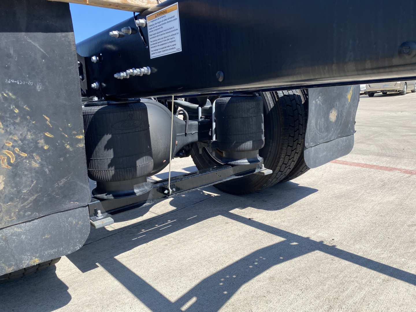 Mack MD6 E truck undercarriage showing dual air tanks and suspension components.