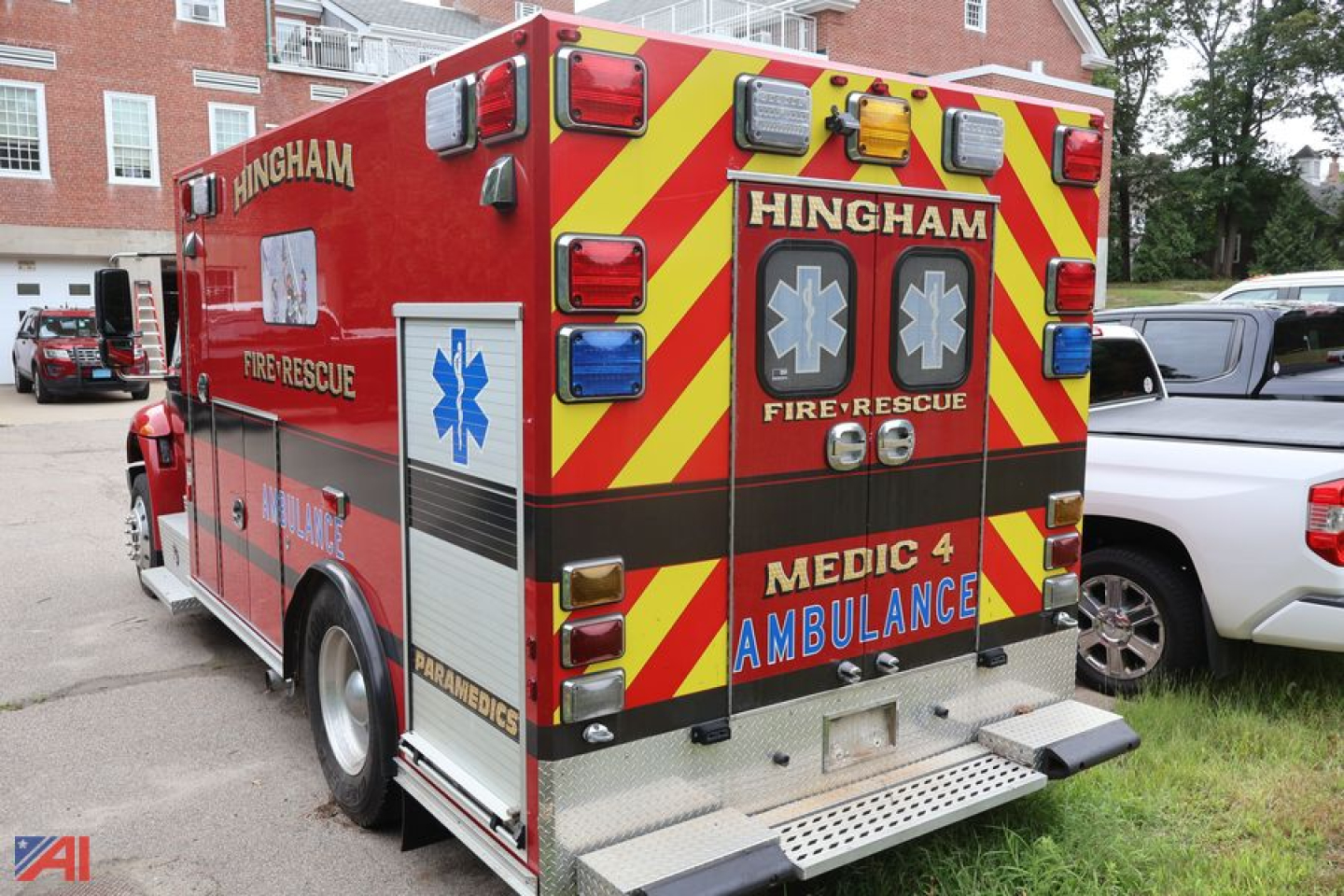 Ambulance rear view showing Hingham Fire-Rescue MEDIC 4 AMBULANCE with chevron pattern and Star of Life symbols.
