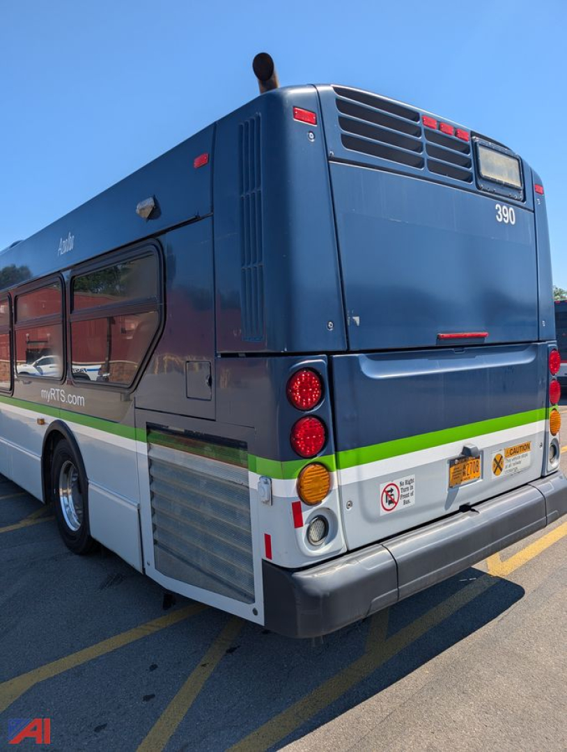Bus rear view showing blue transit bus with rear vents, taillights, and bumper; model number 390; New Flyer XD60 style with green and white stripe along side.