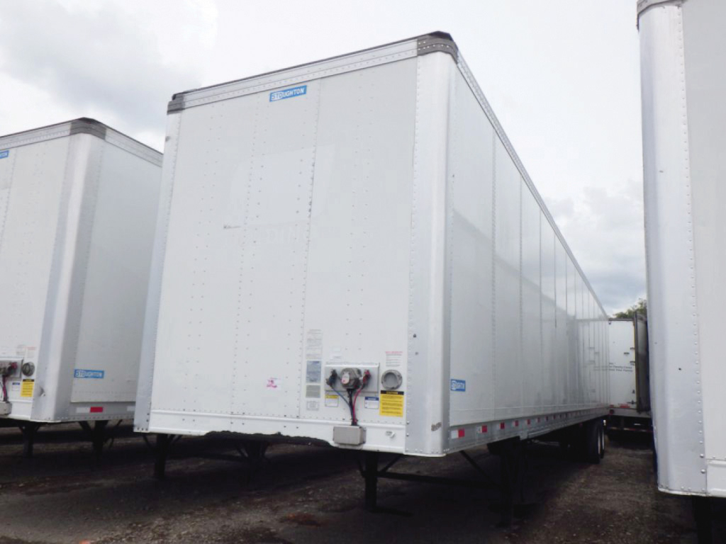 Trailer hitch area of a 2022 Stoughton Z-Plate van showing front of a white box trailer with landing gear and underside support.