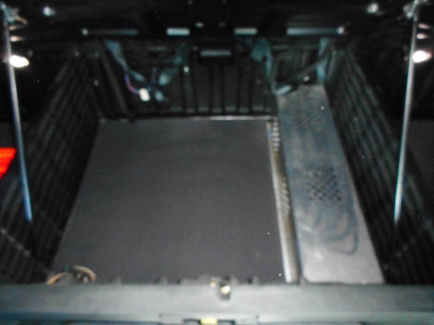 Cab interior of a 2022 Freightliner Cascadia 126 sleeper showing empty floor area in cargo/steps area.