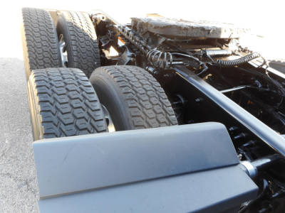 Freightliner Cascadia chassis showing dual rear axles and tires with mechanical framing components visible