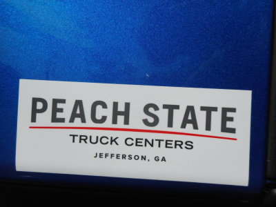 Sticker on blue surface reading PEACH STATE TRUCK CENTERS JEFFERSON, GA