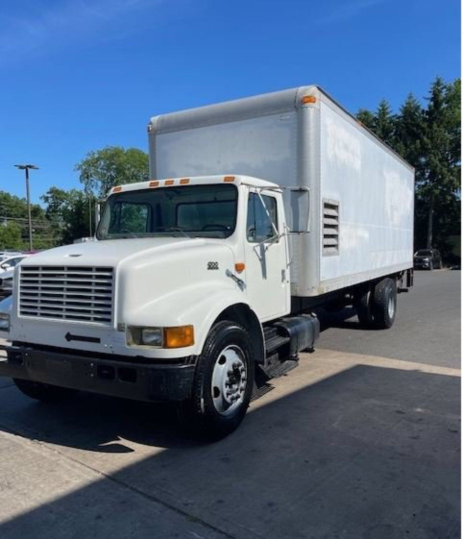International 4000 series box truck side view showing cab and large box cargo body, white with black bumper and wheel wells.