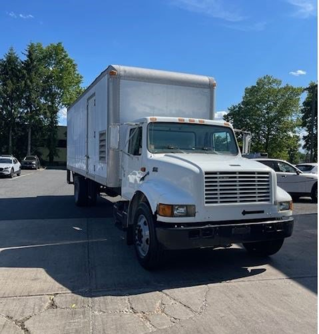 International 4000 Series box truck with a raised box, front grille and cab. Visible text includes model styling on the truck; no legible labels or fluids identifiable in the image.