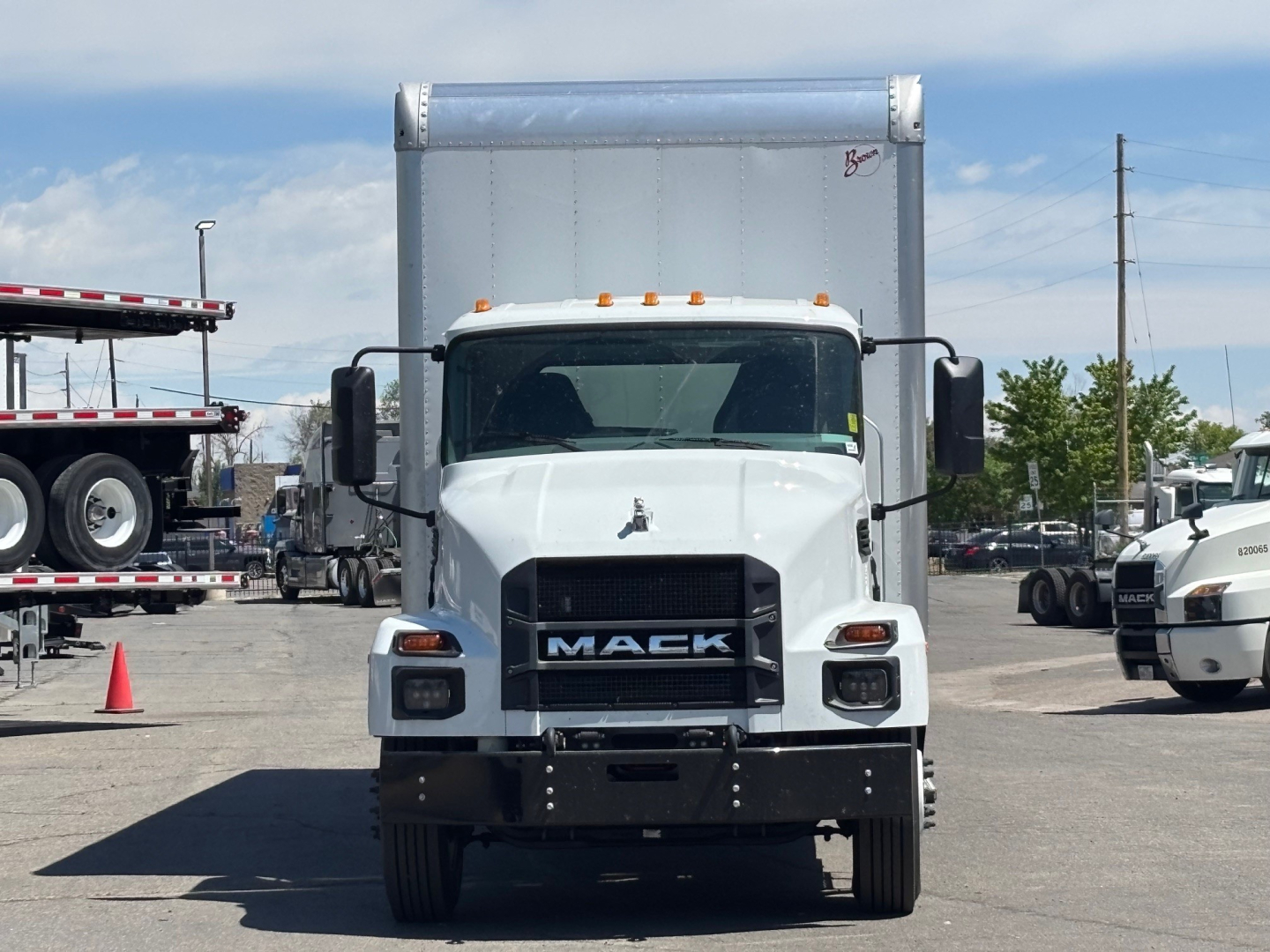 Front view of a white 2026 Mack MD6 box truck showing Mack grille and headlights.