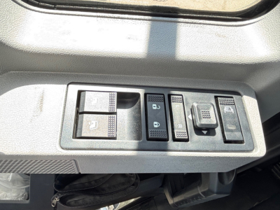 Mack MD6 interior door control panel showing window/lock controls and mirror switch.