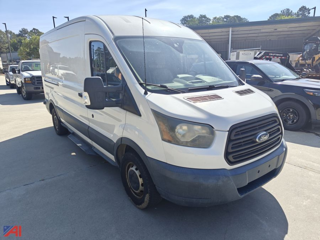 Ford Transit 2016 cargo van in-service showing front grille and side view with white body and black bumper.