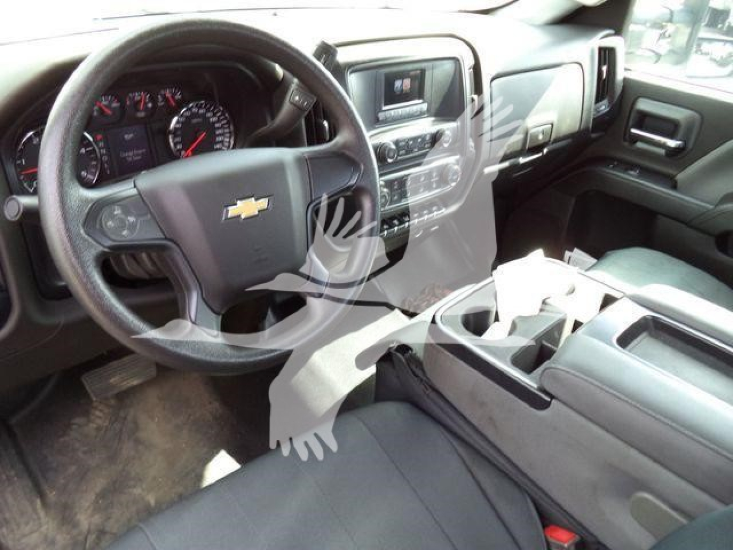 Chevrolet Silverado 6500HD interior view showing steering wheel with Chevy emblem, dashboard, center console, and front seats.