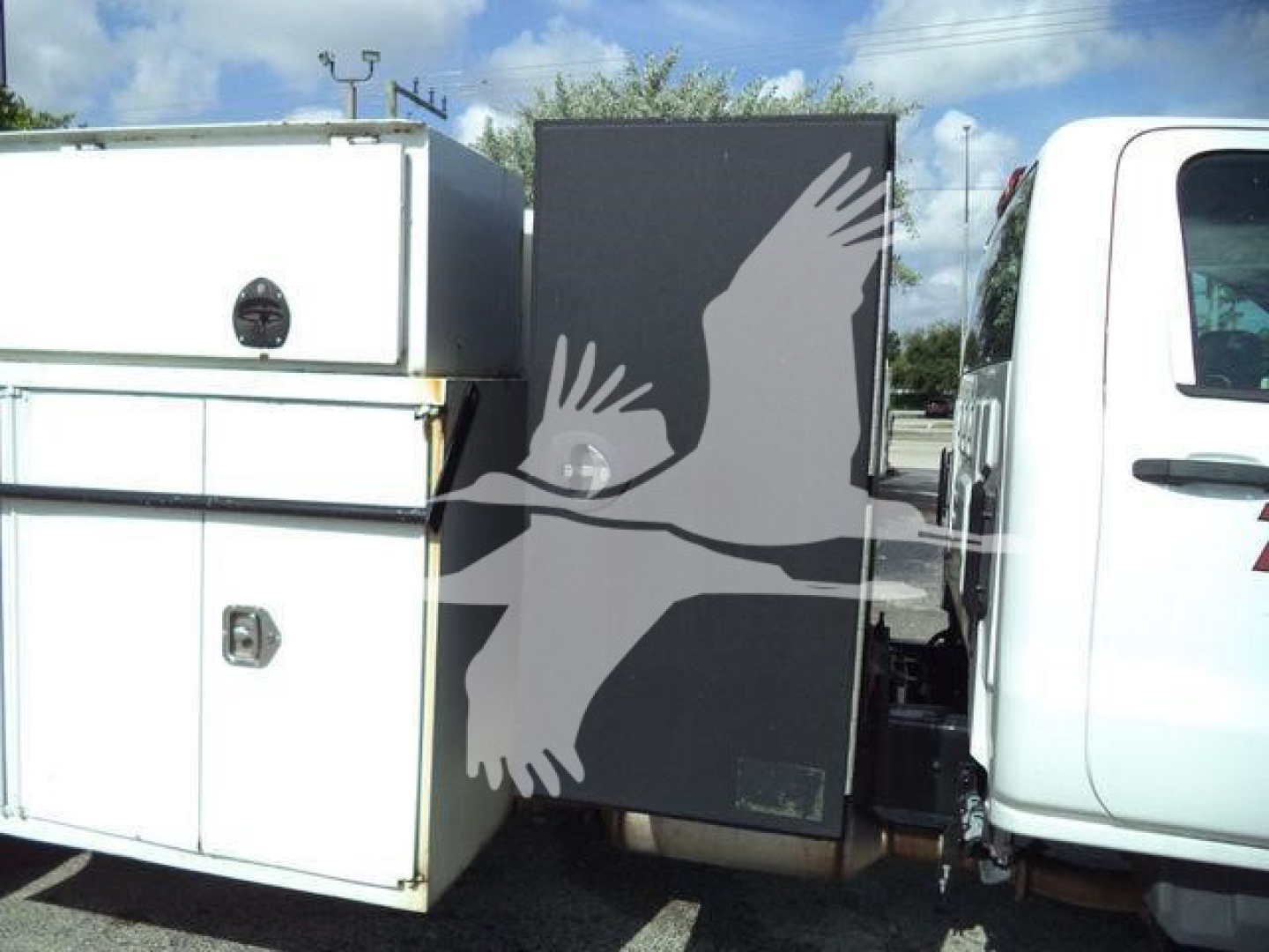 Chevrolet Silverado 6500HD service truck cab and utility body with side compartments.