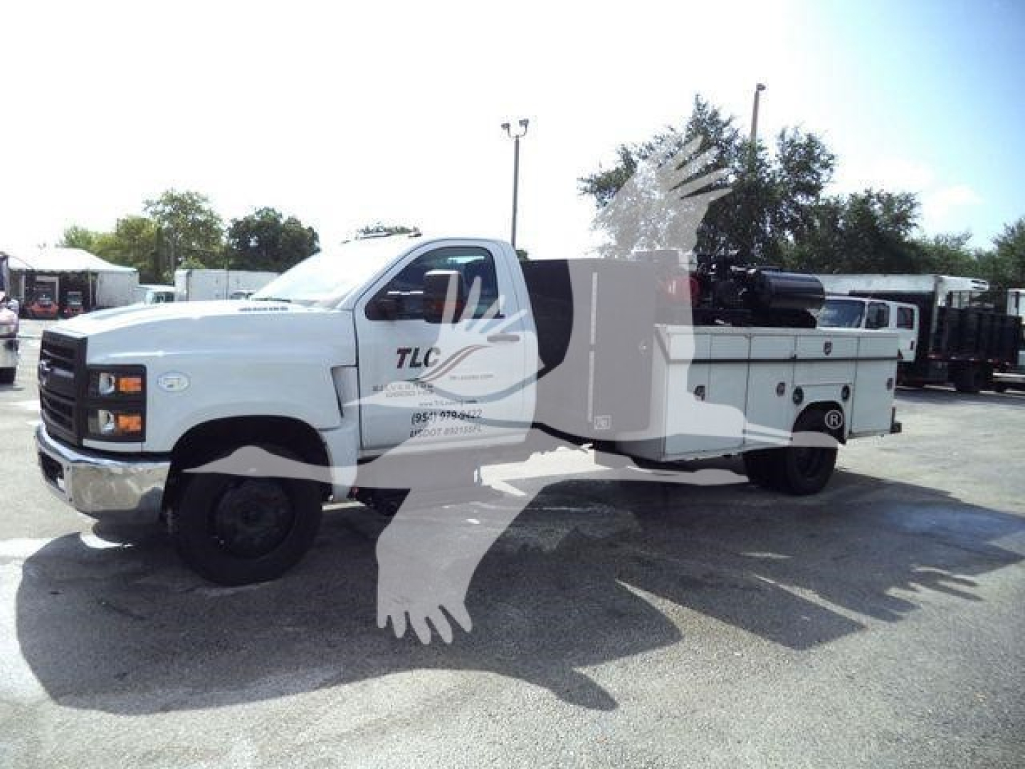Chevrolet Silverado 6500HD service/utility truck in a light color with utility bed and crane.