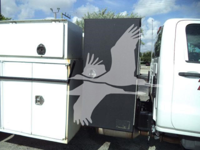 Chevrolet Silverado 6500HD service truck cab and utility body with side compartments.