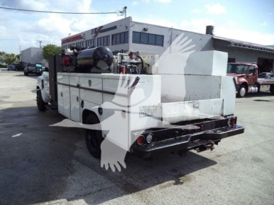 Service/Utility truck rear view showing utility bed with storage compartments and equipment mounted on Silverado 6500HD chassis.