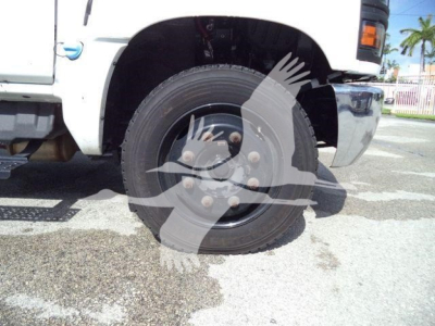 Truck wheel and front fender of a 2023 Chevrolet Silverado 6500HD service/utility vehicle with visible tire and hub.
