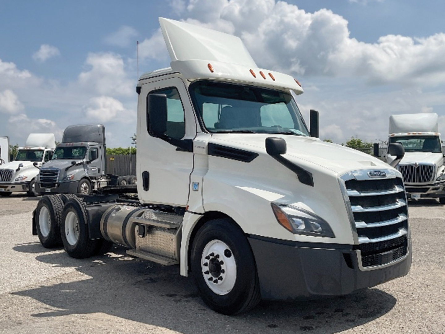 2019 Freightliner Cascadia126 conventional day cab truck in a used condition, white exterior, side view showing tractor cab and rear dual axles, no trailer attached.