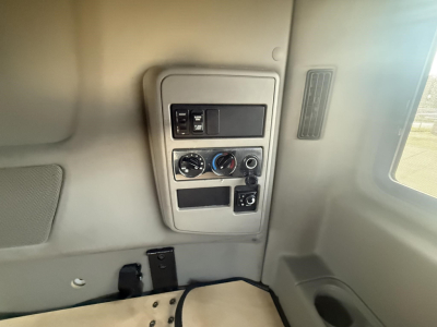 Interior cabin panel of a 2020 International LT showing control switches, climate controls, and storage pocket in view