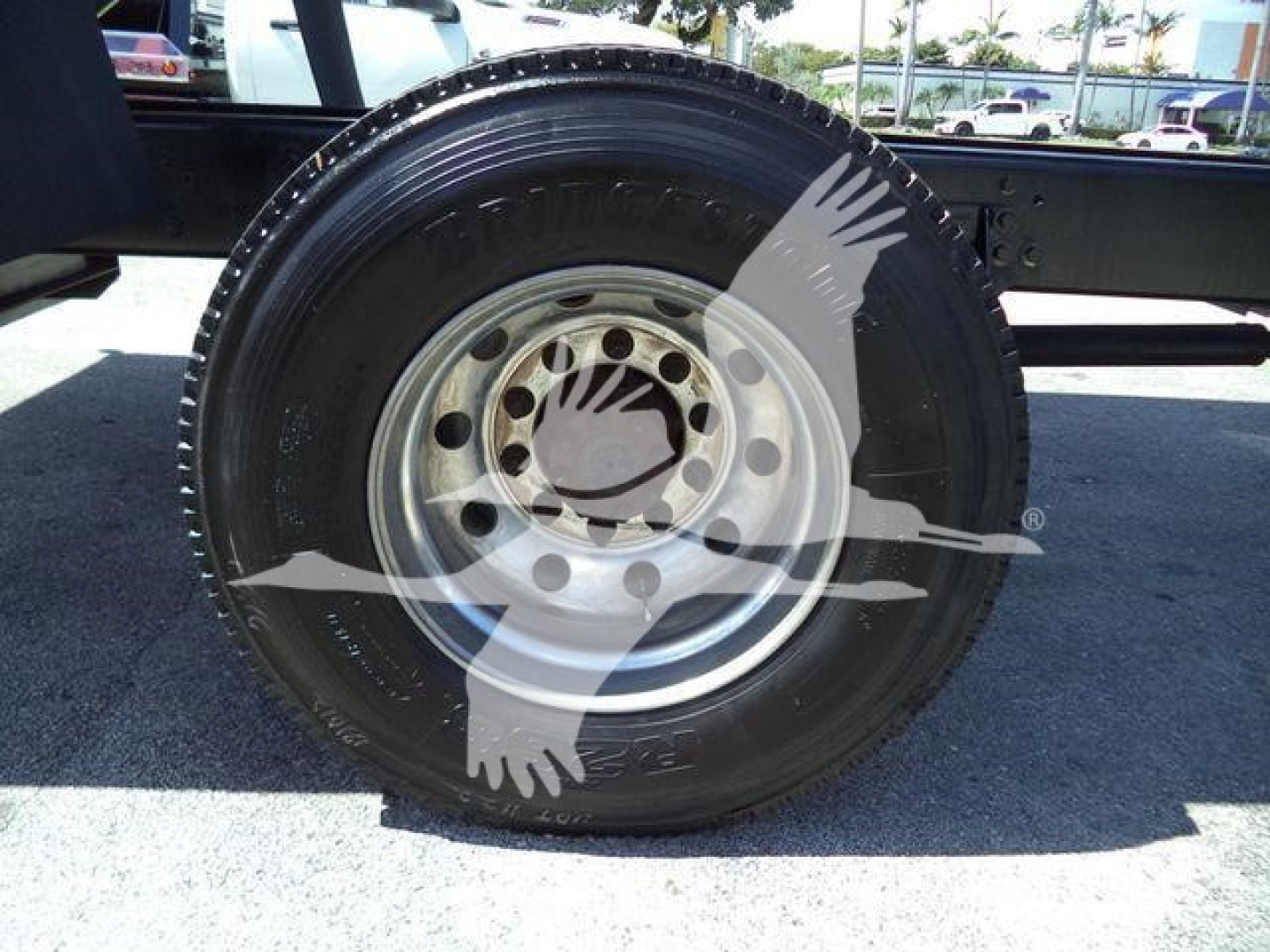 Wheel and tire on a dump truck axle showing steel wheel and black tire
