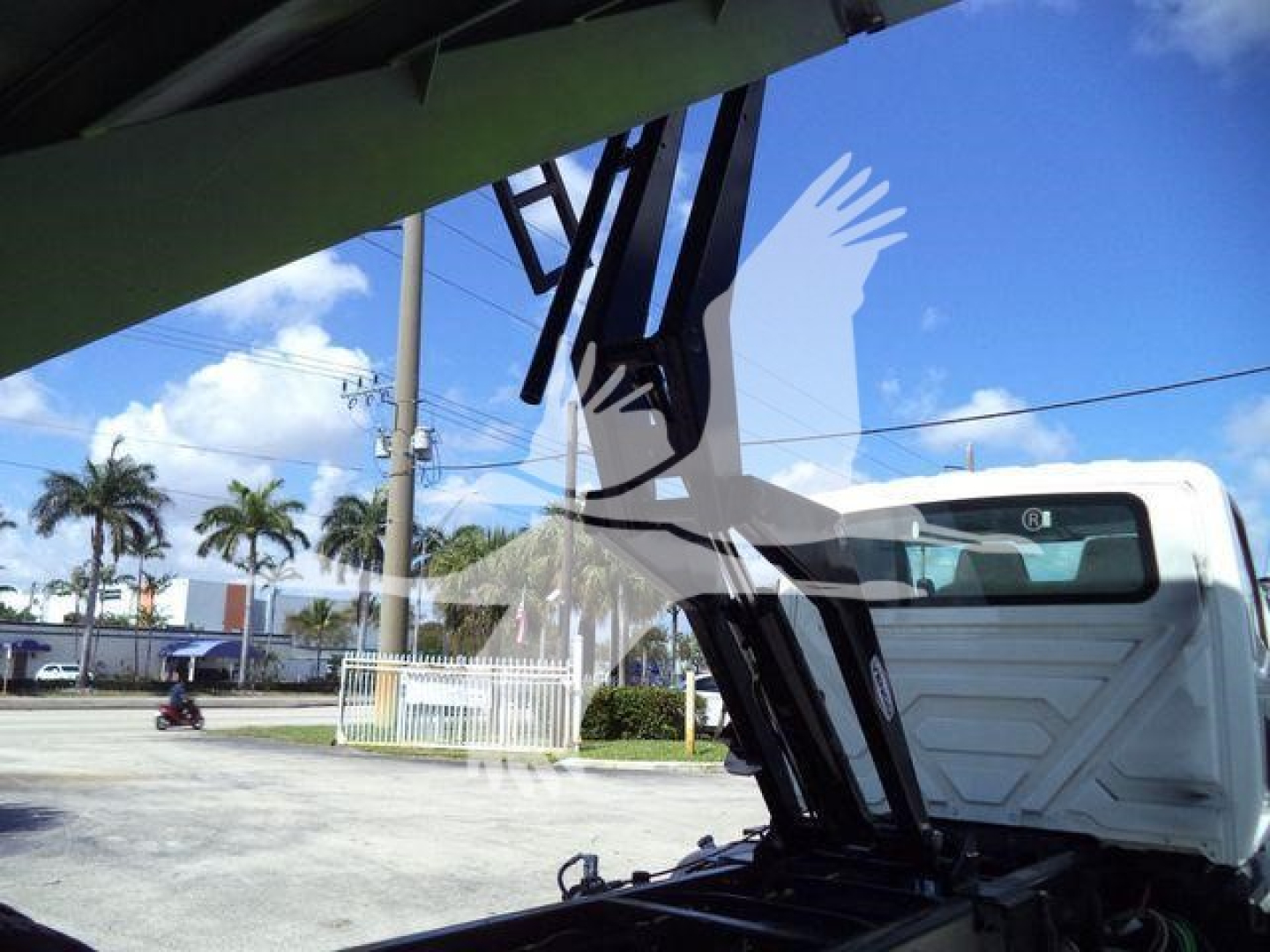 Truck cab with raised hood of a dump truck seen from side; no legible labels or text visible in image.