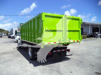 Dump truck rear view showing bright green dump bed and tailgate with 2020 International MV truck.
