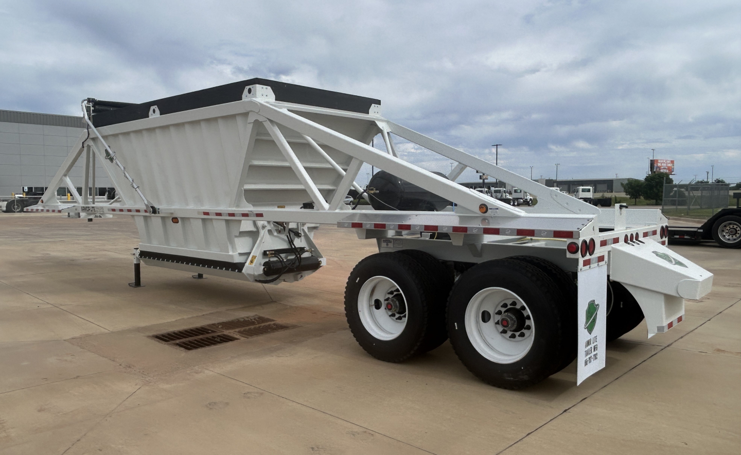 Trailer body showing Armor Lite SBD40 air dump trailer with dual axles, white frame, and landing gear