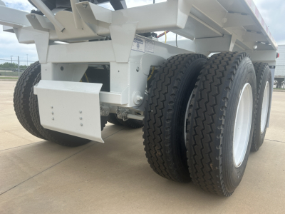 Armor Lite SBD40 air dump trailer undercarriage showing dual rear axles with heavy-duty tires and white frame components.
