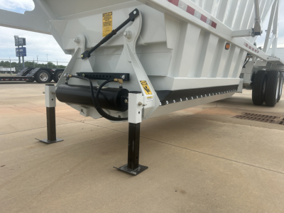 Trailer landing gear and hydraulic actuator on Armor Lite SBD40 air-skeleton dump trailer showing support legs and frame components.
