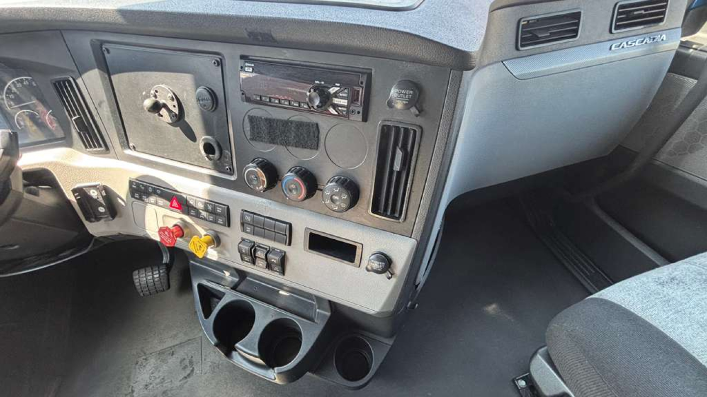 Dashboard of a Freightliner PT126064ST cab showing instrument panel with vents, gauges, and controls.