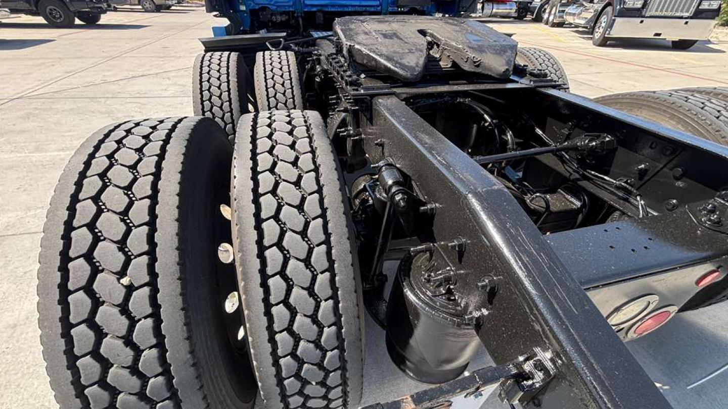Truck chassis rear view showing dual rear tires and frame with components, 2022 Freightliner PT126064ST context text visible in listing.
