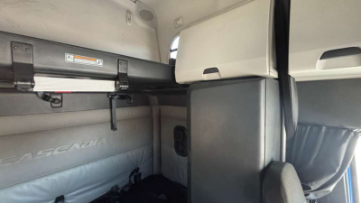 Freightliner PT126064ST cab interior showing bunk area, storage shelf, and paneling.