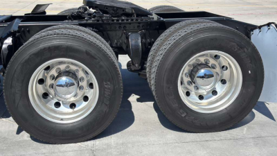 Heavy-duty dual rear axle on Freightliner PT126064ST showing dual 22.5 inch wheels with polished chrome center hubs and tires.