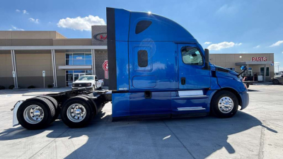 Freightliner tractor cab side view showing blue sleeper unit and rear dual wheels