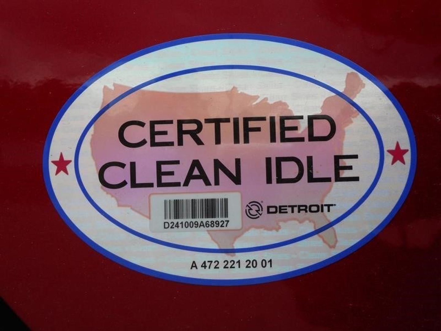 Sticker on red surface reading CERTIFIED CLEAN IDLE with Detroit logo and barcode